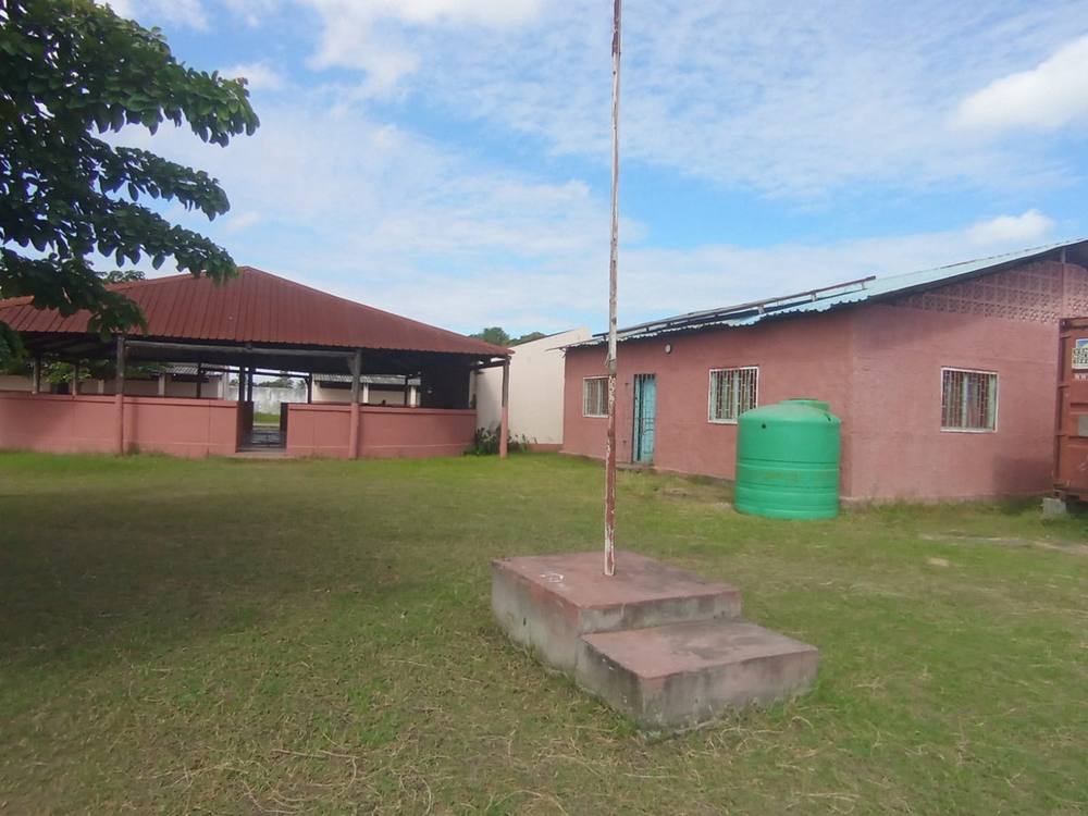 School grounds with flagpole and water tank.
